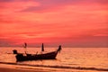 Silhouette of fishing boat on sea beach with sunset background Royalty Free Stock Photo