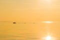 Silhouette of a fishing boat in the sea. Quiet beautiful golden sunset on the sea. Summer nature background Royalty Free Stock Photo