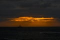 Silhouette of a fishing boat in the sea at sunset.