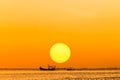 Silhouette fishing boat on sunset