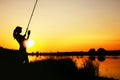 Silhouette of a fishing woman at dawn Royalty Free Stock Photo
