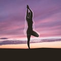 Silhouette of fit woman doing yoga over sunset Royalty Free Stock Photo
