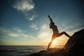 Silhouette of fitness woman doing exercises on the sea beach Royalty Free Stock Photo