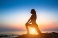 Silhouette fitness yoga women on the coast.