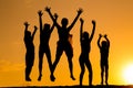 Silhouette of five jumping kids against sunset Royalty Free Stock Photo