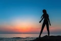 Silhouette flexible girl on the shore of Sea.