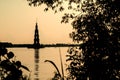 Silhouette of a flooded bell tower in the city of Kalyazin and coastal trees against the evening sky, Russia Royalty Free Stock Photo