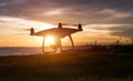Silhouette of flying drone in sunset time. Royalty Free Stock Photo
