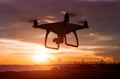 Silhouette of flying drone in sunset time. Royalty Free Stock Photo