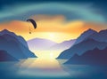 Silhouette of flying paraglider, who take a selfie with action camera above the mountain lake at sunrise