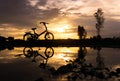 Silhouette folding bike park on the waterfront. Royalty Free Stock Photo