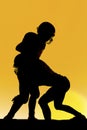 Silhouette of football player making a tackle Royalty Free Stock Photo