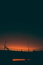 Silhouette of a footbridge and lamppost against a beautiful ombre  sunset sky Royalty Free Stock Photo