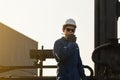 Silhouette of Foreman worker in hardhat and safety vest talking on two-way radio control loading containers box from cargo Royalty Free Stock Photo