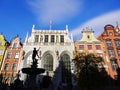 Silhouette of the fountain of Neptune and traditional buildings in the old town Gdansk, Poland