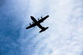 Silhouette four engine propeller airplane on sky