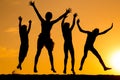 Silhouette of four jumping kids against sunset Royalty Free Stock Photo