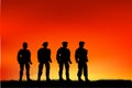 Silhouette of four soldier, low angle perspective, at sunset or sunrise