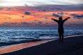 Silhouette of free woman enjoying freedom feeling happy at beach