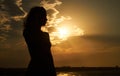 Silhouette of free woman at sunset on the beach Royalty Free Stock Photo