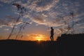 Silhouette of free woman enjoying freedom feeling happy at sunset. Serene relaxing woman in pure happiness