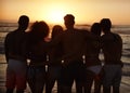 Silhouette Of Friends On Beach Vacation Watching Sunset Over Sea Royalty Free Stock Photo