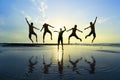 Silhouette of friends jumping over sun Royalty Free Stock Photo