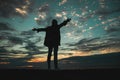 Silhouette of a man with outstretched arms to the sky