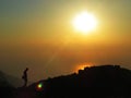 Silhouette in front of a sunset over the ocean