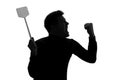 Silhouette of furious man trying to kill mosquito with fly swatter. Royalty Free Stock Photo