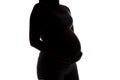 Silhouette of future mother half turned, no face