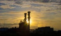 Silhouette of gas turbine power plant at sunset which create pollution and global warming cause ozone layer depletion for