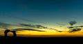 Silhouette Gate Destroyed temple against amazingly beautiful sunset and sky