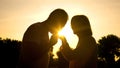 Silhouette of gentleman kissing wife's hand, senior couple in love, romance