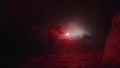 Silhouette of a geologist examining dark cave, holding red signal flare. Stock footage. Scientist man exploring stony