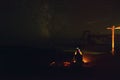 Silhouette of a girl at the bonfire on the beach