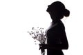 Silhouette of a girl with a bouquet of dry dandelions looking up, the face profile of a young woman on a white isolated background Royalty Free Stock Photo