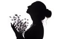 Silhouette of girl with a bouquet of flowers, woman face profile looking upwards on a white isolated background Royalty Free Stock Photo