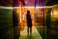 Silhouette of a girl in colorful plexiglas corridor