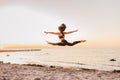 Silhouette of girl dancer in a split with sunset or sunrise background and copy space. Concept of heathy life, goob body and youth