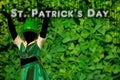Silhouette of a girl that dress a green cap that dances on Green Background with golden cascade of lights fot saint patrick day.