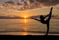 Silhouette of girl enjoying her morning dance exercise at a beach sunrise