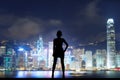 Silhouette girl in front of night modern city