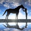 Silhouette of a girl giving a kiss horse