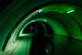 Silhouette of girl in green tunnel Royalty Free Stock Photo