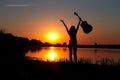 Silhouette of girl with a guitar on a sunset Royalty Free Stock Photo