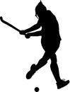 Silhouette of girl hockey player hitting ball