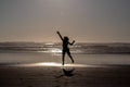Silhouette of a girl jumping high on a beach Royalty Free Stock Photo