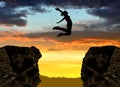 Silhouette the girl jumping over the gap Royalty Free Stock Photo