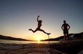 Silhouette of girl jumping at sunset on the beach Royalty Free Stock Photo